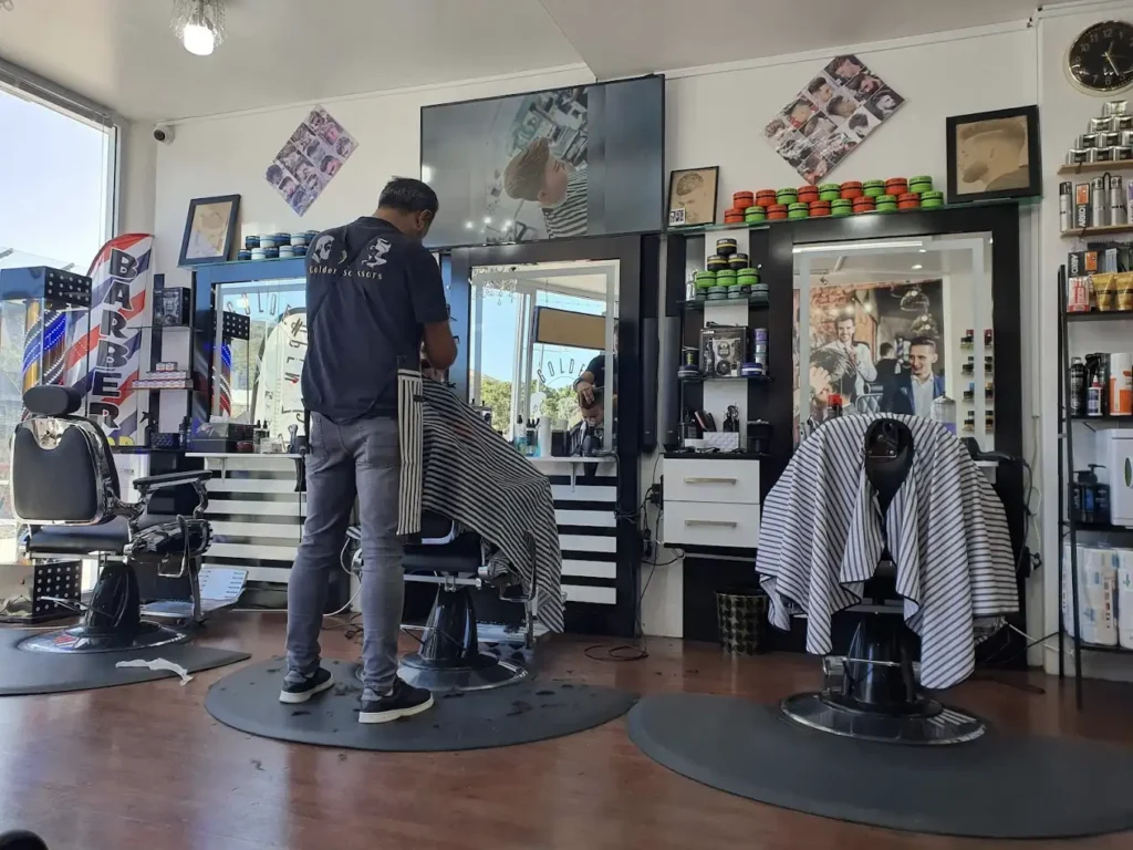 Golden Scissors barber cutting hair